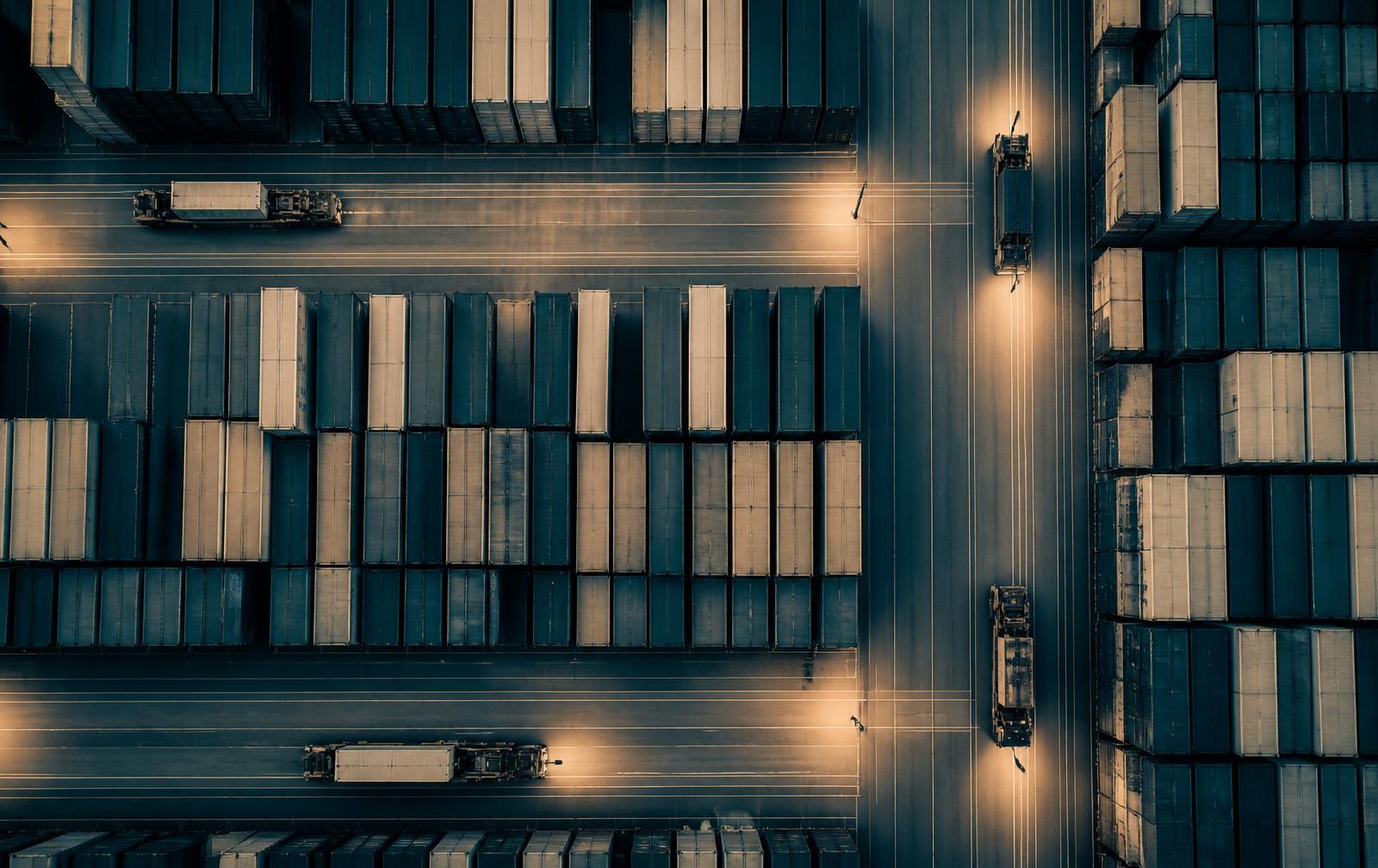 Aerial view of a container terminal with truck lanes at blue hour